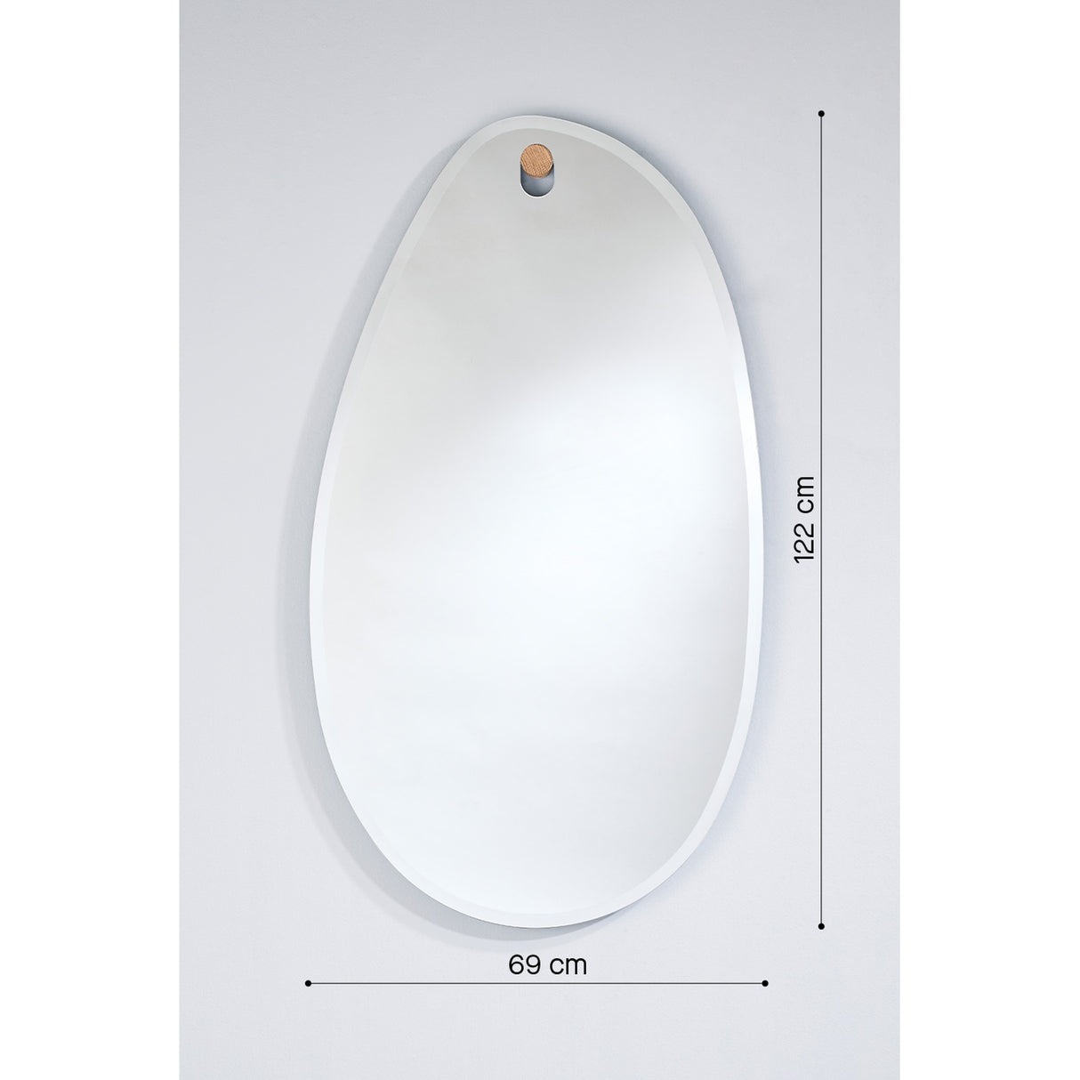 Frameless Globo Lago wall mirror in an irregular organic shape with bevelled edge, hung from a single oak peg, shown with dimensions 122cm by 69cm on a light background.