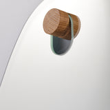 Close-up of the natural oak peg, the second finish supplied, seated in the hole at the top of the glass.