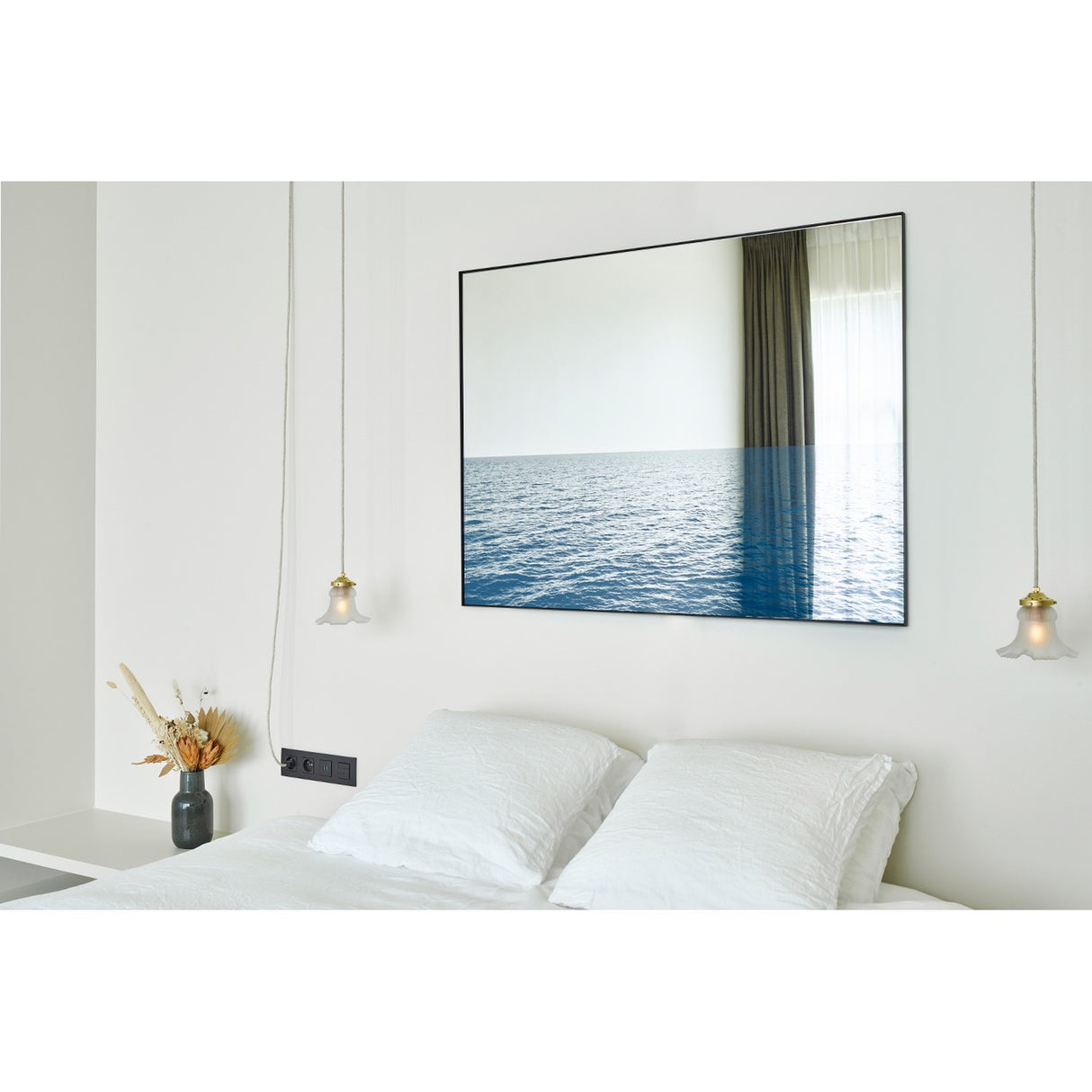 Maro Seascape Printed Glass Wall Mirror 120cm in a black rectangular frame above a bed, with a mirrored upper half and printed blue seascape across the lower section.