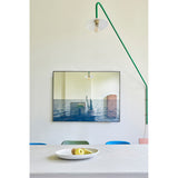 Maro Seascape Printed Glass Wall Mirror 120cm in a black rectangular frame, hung above a dining table, blending a printed seascape below with a mirrored surface above.