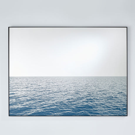 Maro Seascape Printed Glass Wall Mirror 120cm, rectangular black-framed mirror with a printed blue seascape below the horizon and a mirrored sky above, on a plain light grey wall.