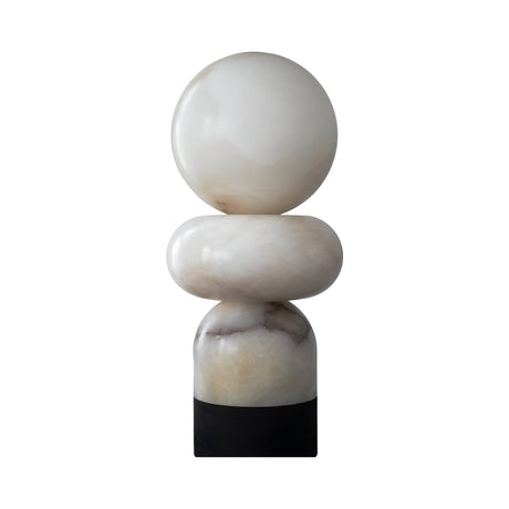 The Talmera 1 Light Large Sculptural Sphere Alabaster Table Lamp in soft white and black features stacked rounded alabaster shapes on a black cylindrical base, creating a striking sculptural accent against a white background.
