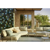 Lucka Outdoor Full Length Garden Mirror 175cm in black, shown as three slim rectangular panels with black metal frames set into a tan wall on an outdoor patio with sofas.