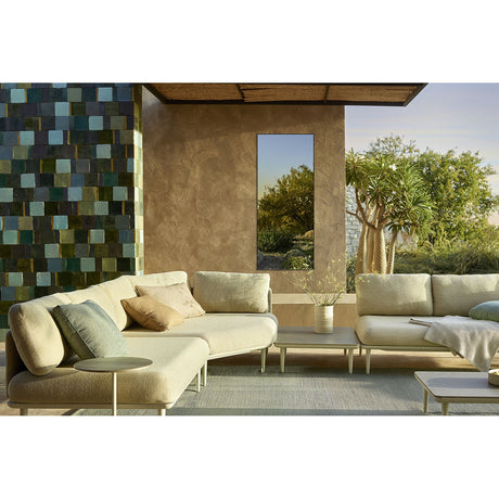 Lucka Outdoor XL full length garden mirror, 175cm, rectangular with slim black metal frame, mounted on an outdoor patio wall reflecting greenery beside cream sofas.