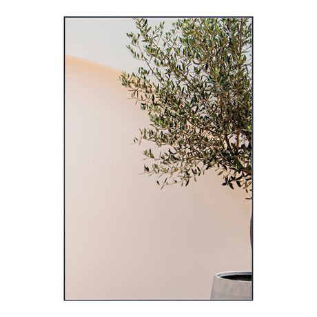 Lucka Outdoor Rectangular Garden Mirror 120cm in black, slim metal frame, shown beside olive tree branches against a plain light wall.
