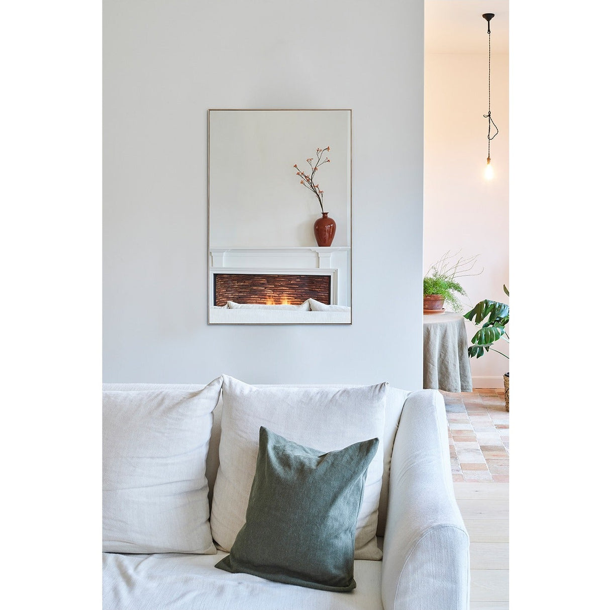 Lucka Solid Oak Full Length Mirror mounted above a mantel in a living room, rectangular with a slim recessed oak frame reflecting a vase and lit fireplace.