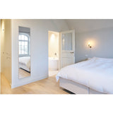 Lucka Solid Oak Full Length Mirror mounted on a bedroom wall, rectangular with a slim recessed oak frame, reflecting a window and bed.