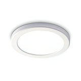 The Lucella Recessed Round LED Downlight, boasting a sleek, modern design with a white finish, is mounted on the ceiling. This energy-efficient 20W fixture emits a soft and even 4000K glow.