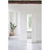 Echo White Double Sided Free Standing Mirror 193cm with a stacked slat metal frame and rounded base, shown in a light hallway setting.