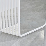 Close-up of the Echo White Free Standing Mirror's base, showing white powder coated metal slats curving round to support the mirrored panel, set on a concrete floor.