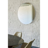 Matin frameless round wall mirror, 100cm, with hand-applied dewdrop texture across the glass, shown above a dining table in a whitewashed brick room.