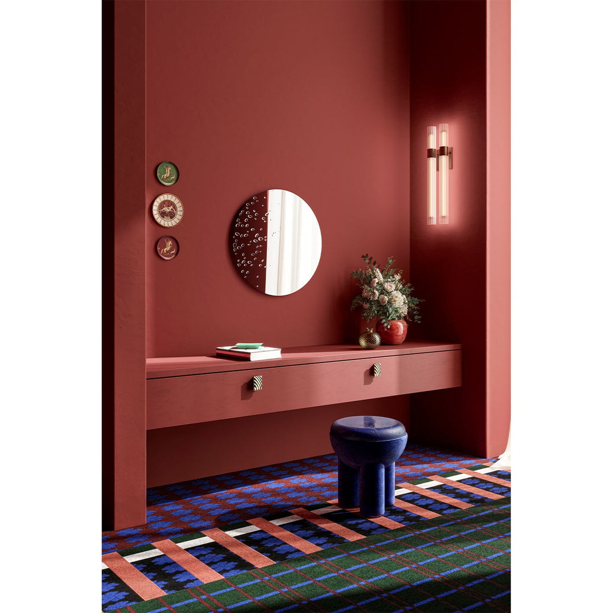 Matin Hand Applied Dewdrop Round Wall Mirror 60cm, frameless with raised dewdrop details across the lower edge, styled above a hallway console in a red-toned room.