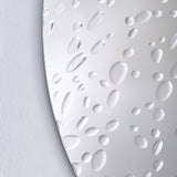 Close-up of the raised drops on the glass, varying from a few millimetres to a couple of centimetres.