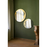 Ornato Gold Leaf Round Rotating Wall Mirror 70cm shown in pairs on a green wall, each frameless round mirror with an irregular hand-applied gold leaf patch on the rim.