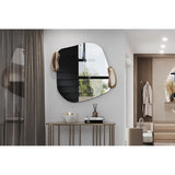 Calco Gold Leaf Sculpted Wall Mirror, 116cm irregular-shaped mirror with sculpted gold leaf forms at the edges, shown above a console table in a hallway setting.