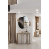 Calco Gold Leaf Sculpted Wall Mirror, 116cm irregular-shaped mirror with gold leaf sculpted side accents, shown above a gold console table in a hallway setting.