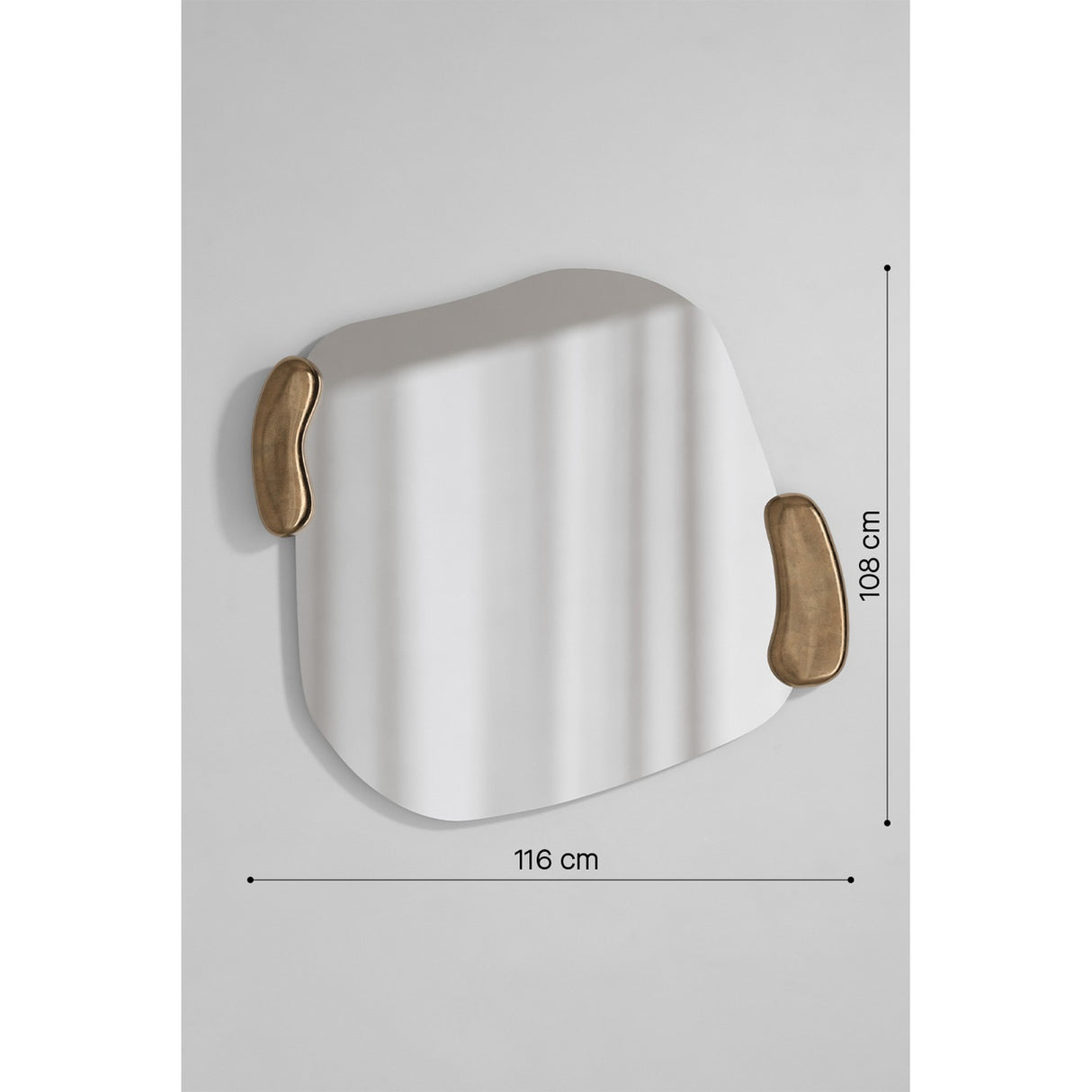 Calco Gold Leaf Sculpted Wall Mirror, 116cm, frameless irregular-shaped mirror with two organic gold leaf handles at the edges, shown with dimensions on a plain grey background.