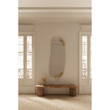 Calco Gold Leaf Sculpted Hall Mirror, 166cm tall oval wall mirror with irregular gold leaf accents at top and bottom, shown above a wooden bench in a hallway setting.