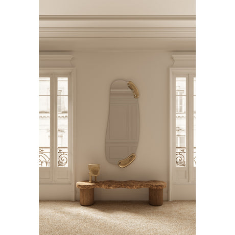 Calco Gold Leaf Sculpted Hall Mirror, 166cm tall oval wall mirror with irregular gold leaf accents at top and bottom, shown above a wooden bench in a hallway setting.