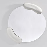 Calco White Sculpted Round Wall Mirror 73cm, with two textured white moulded forms holding opposite edges of an asymmetric glass, shown against a plain light grey background.