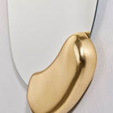 Close-up of the Calco Gold Leaf Sculpted Hall Mirror, showing an irregular frameless mirror edge with a sculpted, hand-applied gold leaf form curving beside it.