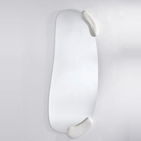 Full length sculpted mirror with an asymmetric glass and two moulded white forms set against it at opposite corners.