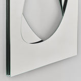 Angled close-up of the Infinito Precision Cut Void Wall Mirror 100cm, showing a white frameless panel with a layered glass edge and an organic cut void revealing mirrored depth beneath.