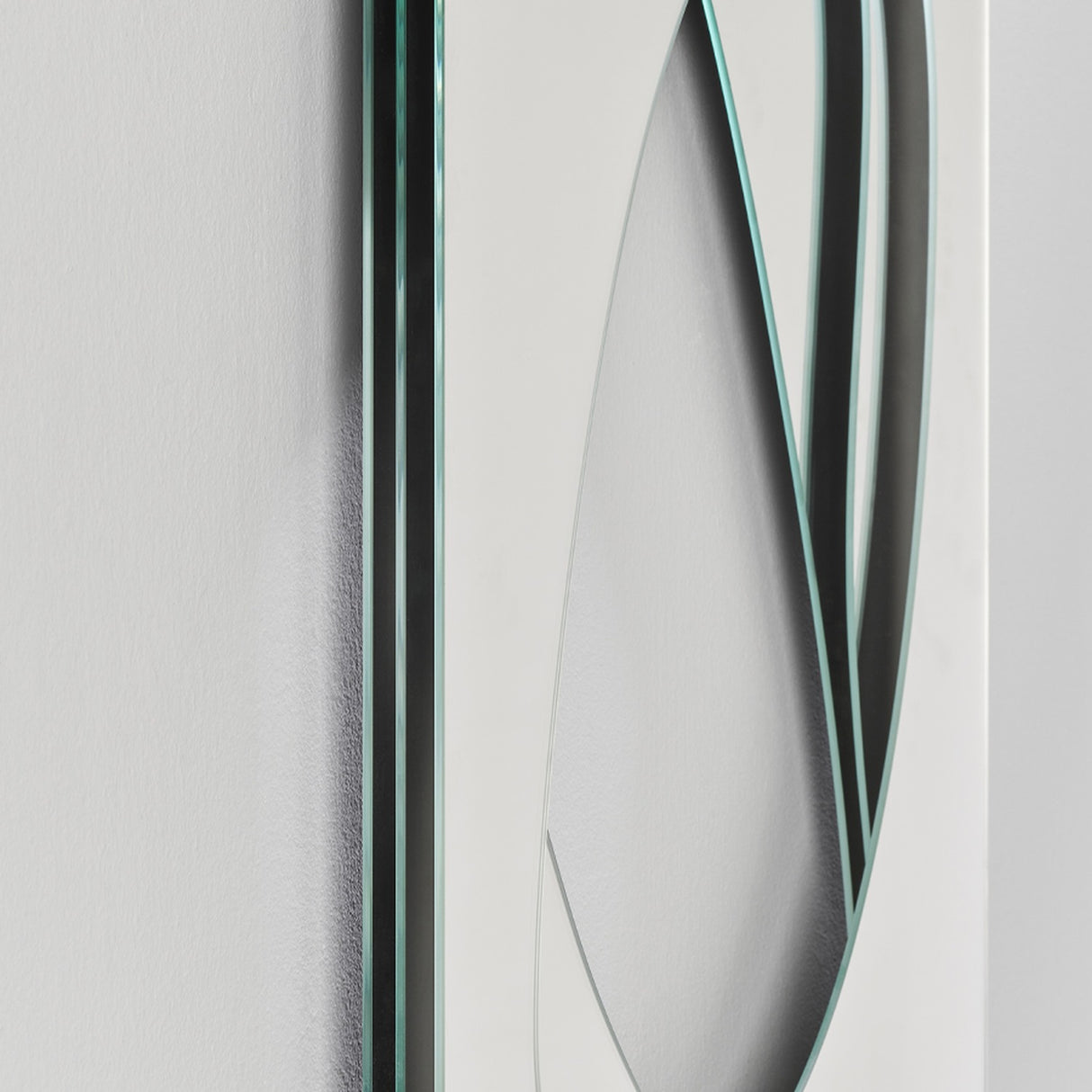 Infinito Precision Cut Void Wall Mirror 100cm, close-up of the white panel with a cut organic void revealing layered mirror strips and thin black and glass edging.