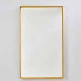 Rectangular wall mirror with a deep ochre velvet box frame and recessed glass, mounted on a plain light grey wall.