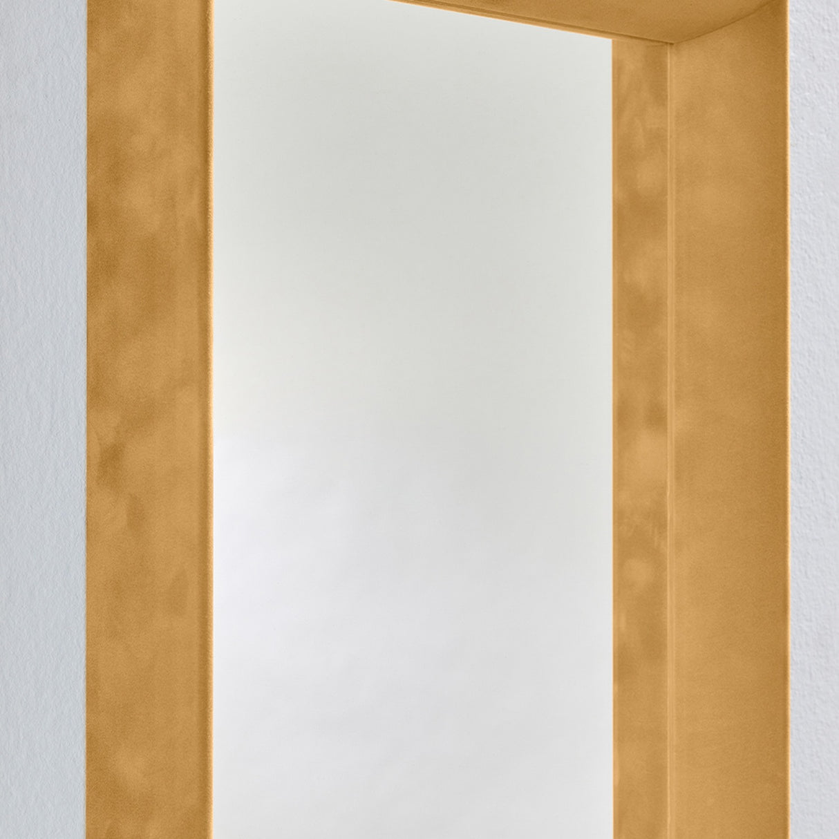 Close-up of the Velvet Ochre Framed Rectangular Wall Mirror, showing the deep box frame in ochre velvet with the recessed glass set back inside, against a plain light wall.