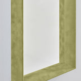 Close-up of the Velvet Green Framed Rectangular Wall Mirror, showing the deep box frame in olive green velvet with a recessed mirror and visible inner return, against a plain white wall.