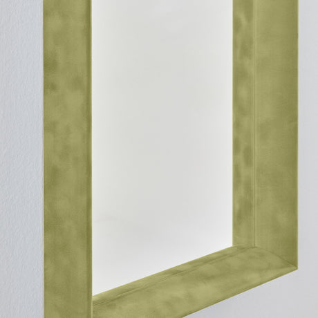 Close-up of the Velvet Green Framed Rectangular Wall Mirror, showing the deep box frame in olive green velvet with a recessed mirror and visible inner return, against a plain white wall.