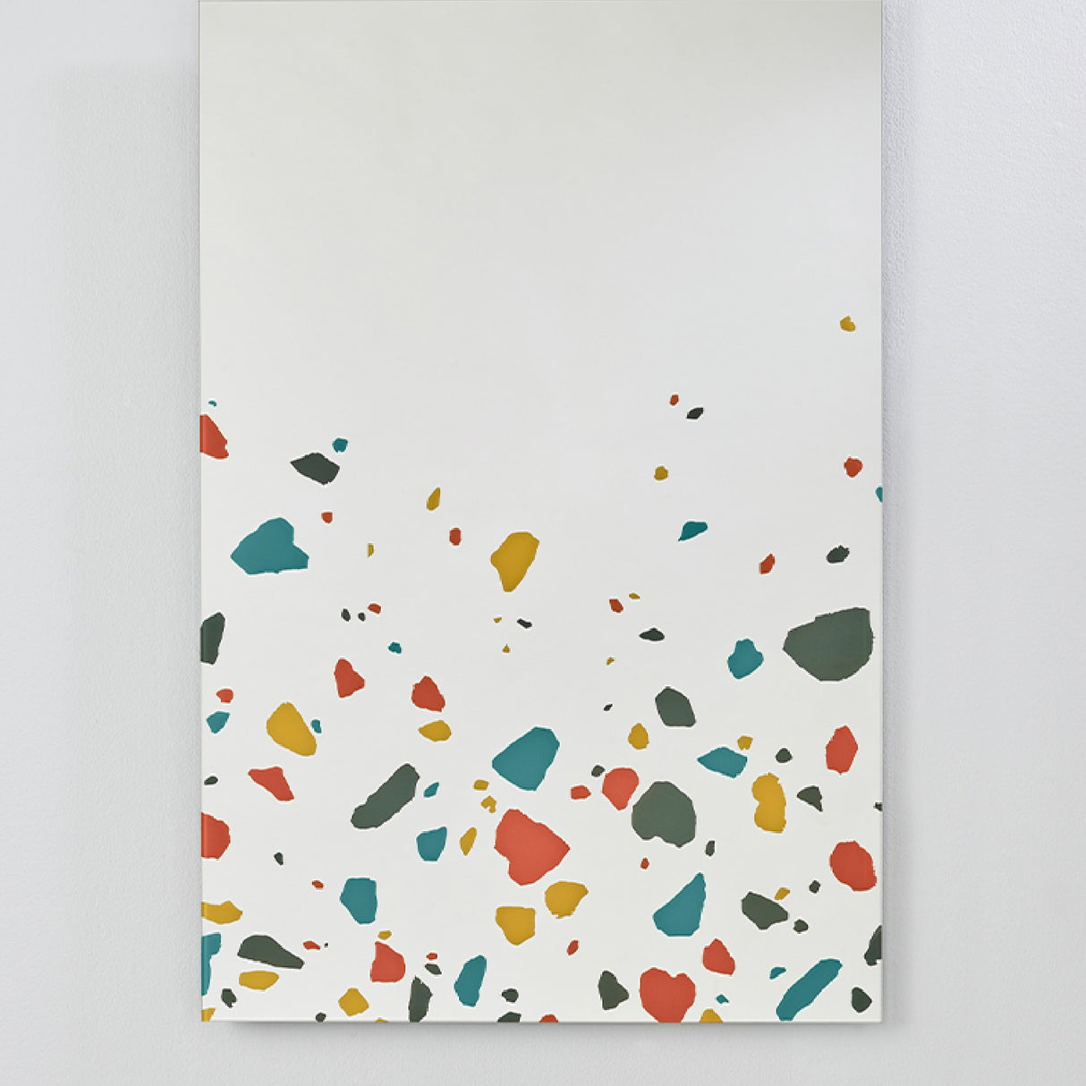 Frameless rectangular glass wall mirror, 120cm, with red, teal, ochre and grey terrazzo print along the lower edge and a plain mirror surface above.