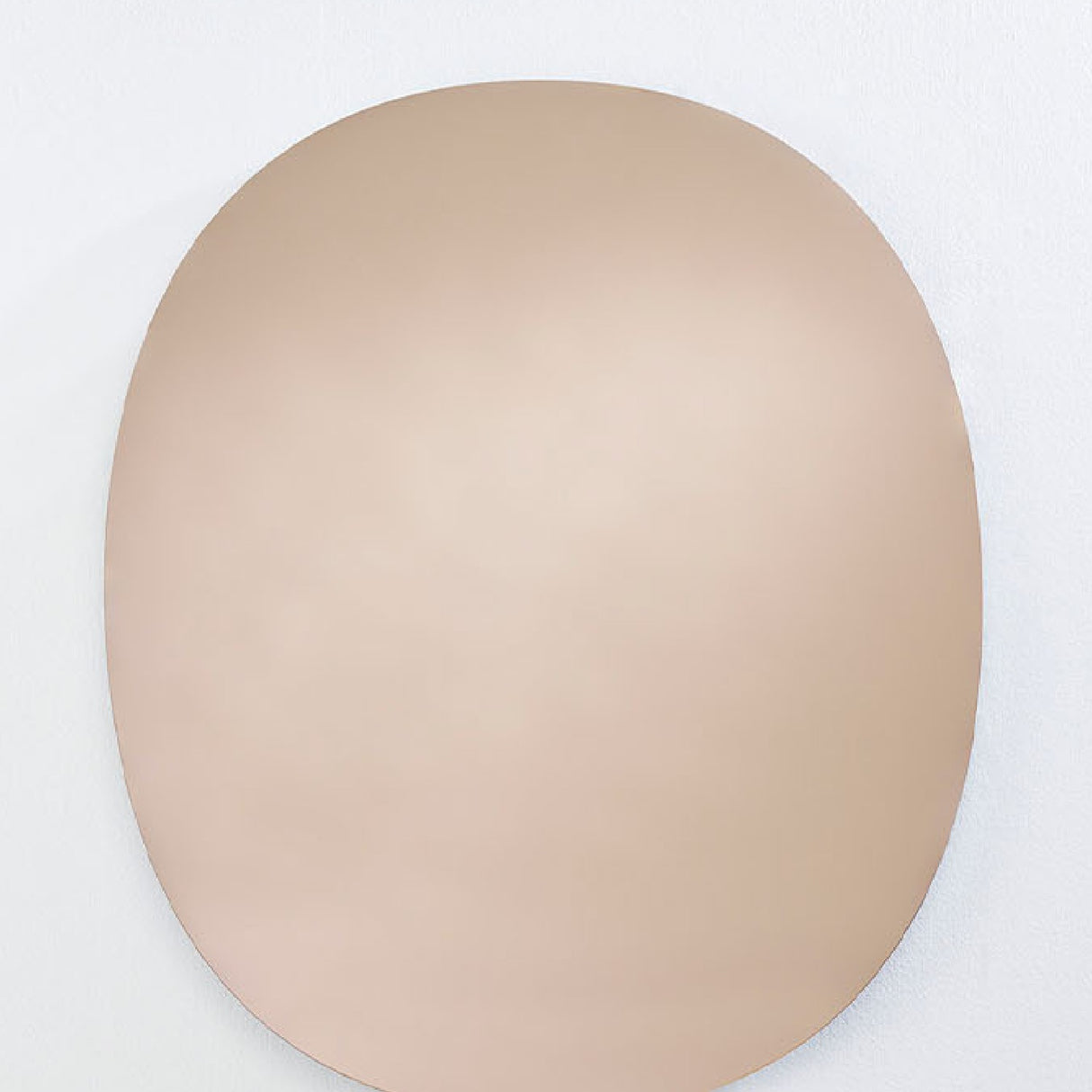 Oval Bronze Tinted Frameless Wall Mirror, 106cm tall, bare polished glass edge with an even bronze tint, mounted on a plain white wall.