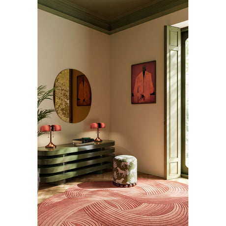 Oval Bronze Tinted Frameless Wall Mirror 106cm displayed above a green console table in a hallway styled with lamps, framed art, and a patterned pouf.
