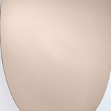 Close-up of the Oval Bronze Tinted Frameless Wall Mirror, 106cm, showing the bare polished glass edge and warm bronze-tinted surface against a plain wall.