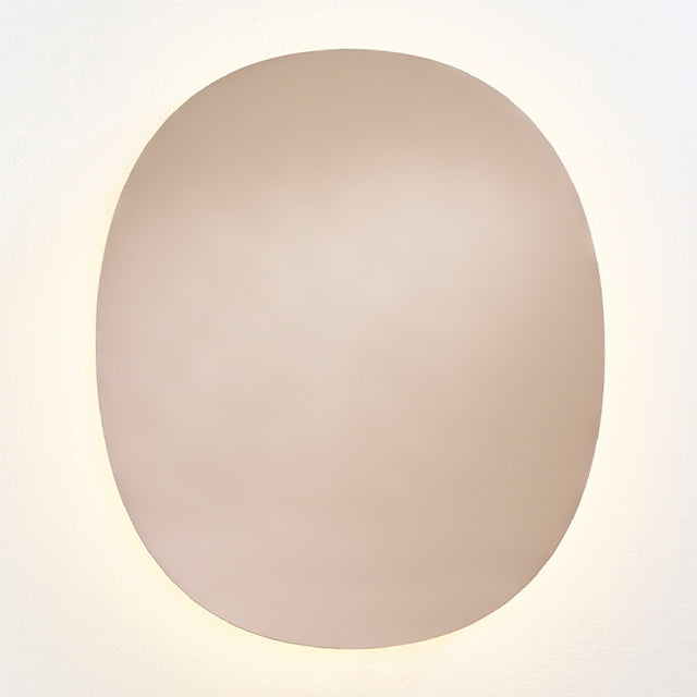 Brio Bronze backlit LED oval wall mirror, 106cm, bronze-tinted glass with a warm LED halo washing onto the wall behind it.