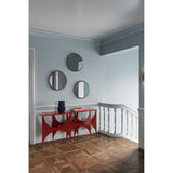 Ray Gold Disc Edged Round Wall Mirror 65cm displayed in a hallway above a red console table, its gold metal discs ringing the glass edge, alongside two smaller matching round mirrors.