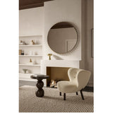Ray Powder Coated Round Wall Mirror 105cm in gold, framed by small interlocking gold discs, hung above a fireplace in a living room setting.