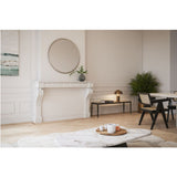 Ray Powder Coated Round Wall Mirror 105cm in gold, framed by small interlocking gold discs, hung above a marble fireplace in a living room setting.