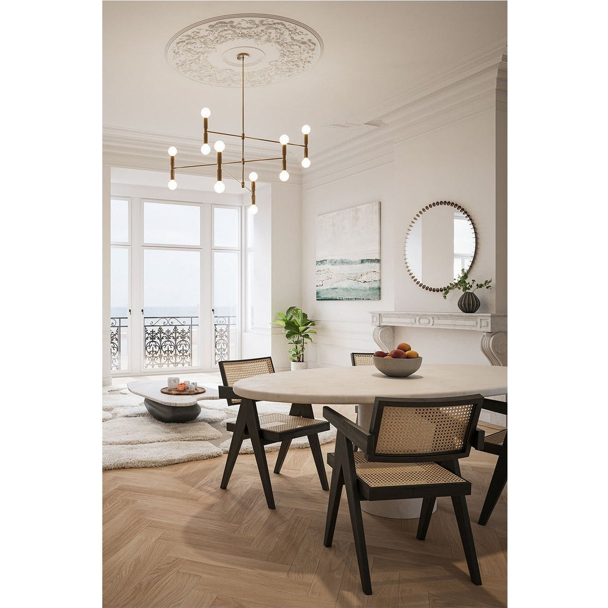 Round wall mirror with a gold powder coated bead-like disc frame, hung above a marble fireplace in a dining room setting.