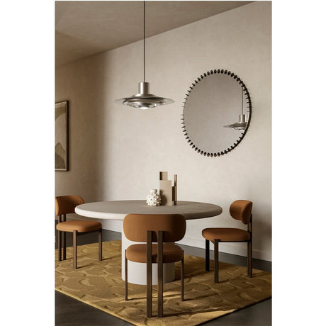 Ray Black Powder Coated Round Mirror with radiating metal spoke frame, reflecting a pendant light, hung above a dining table in a neutral-toned room.