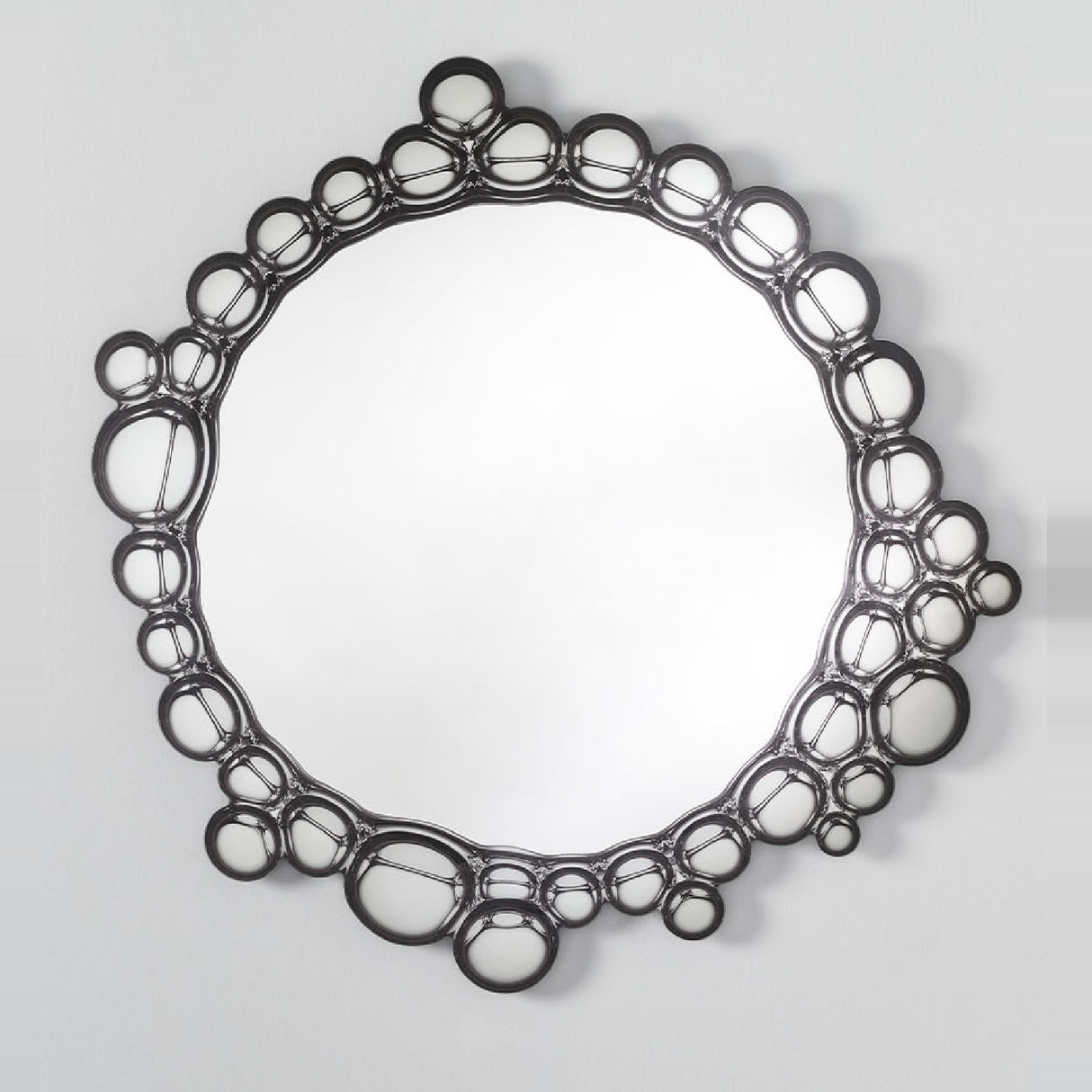The bubble ringed mirror seen straight on, the circles varying in size around the whole of the glass.