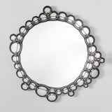 The bubble ringed mirror seen straight on, the circles varying in size around the whole of the glass.