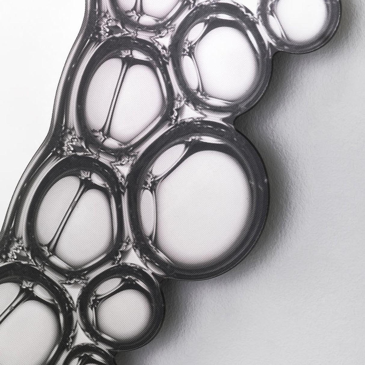 Close-up of the printed bubbles, the silvered circles overlapping and reflecting where they cross.