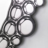 Close-up of the printed bubbles, the silvered circles overlapping and reflecting where they cross.