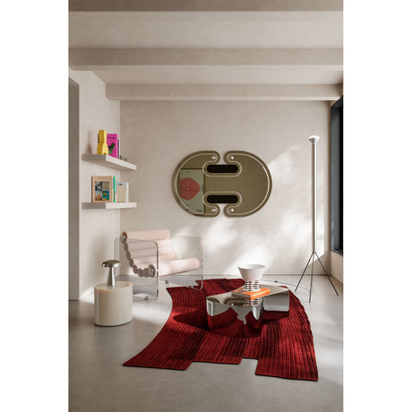 Oval silvered wall mirror with black lacquered ellipse detail and silver-leaf sphere accents, 150cm, mounted above a console in a neutral living room.