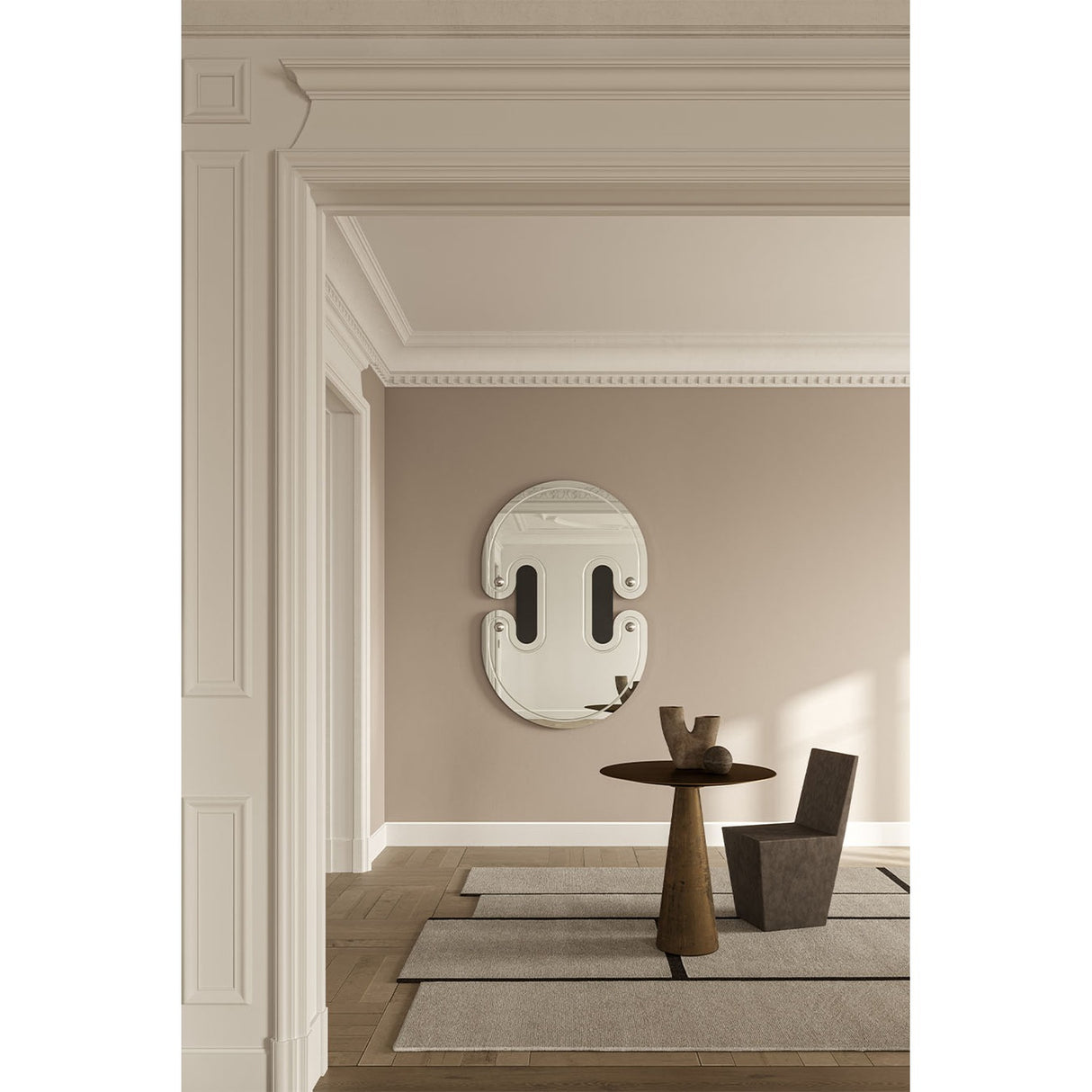 Satellite Silver Leaf Engraved Orbit Wall Mirror 150cm with black lacquered glass ellipses and silver leaf half-sphere accents, mounted on a beige wall above a side table in a hallway setting.