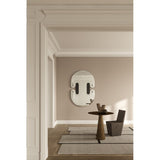 Satellite Silver Leaf Engraved Orbit Wall Mirror 150cm with black lacquered glass ellipses and silver leaf half-sphere accents, mounted on a beige wall above a side table in a hallway setting.