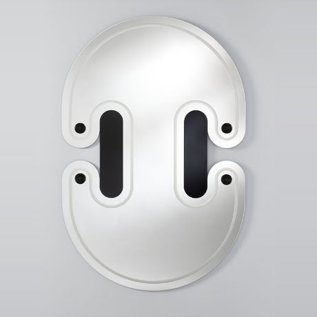 The mirror seen larger, the twin lobed outline with the engraved slots and spheres set across the face.